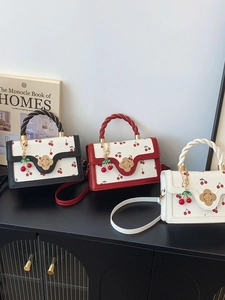 Chic cherry print handbag with braided handles and golden floral clasp in three colors