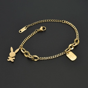 Close-up of gold stainless steel bracelet featuring bunny pendant and engraved charm tag