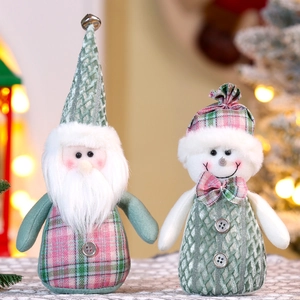Details von Weihnachts-Wichteln und Schneemann-Puppen aus grün-rosa kariertem Strickstoff
