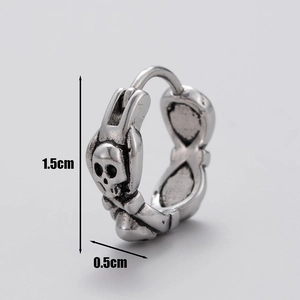 Macro detail of vintage silver skull earring showing 1.5cm height and 0.5cm width dimensions