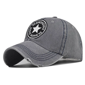 Detail of washed cotton baseball cap with star embroidery and distressed ripped effects
