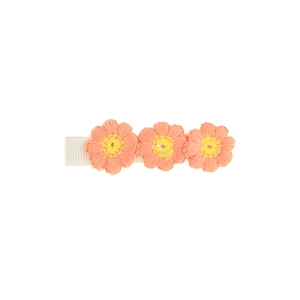 Detail of orange embroidered flower hair clip with three petals and soft white fabric base