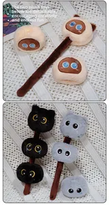Detail showing plush cat trio balls on stick with detachable bottom elements
