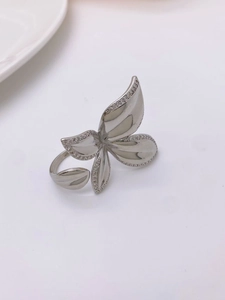 Macro shot of silver floral ring with multi-layer petals and inlaid white zircon stones