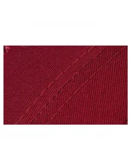 Macro detail of dark red cotton baseball cap fabric with reinforced double stitching