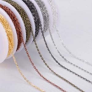 Detailed close-up of multi-color DIY jewelry making link chains on white plastic spools