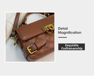 Macro detail of brown quilted leather bag with premium gold metal clasp and chain strap