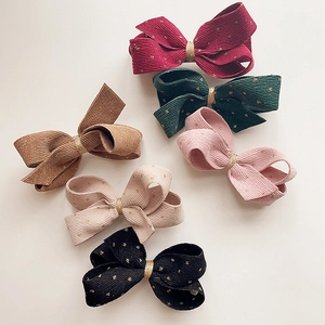 Set of six corduroy hair bows with gold dots in red, green, brown, pink, beige, and black
