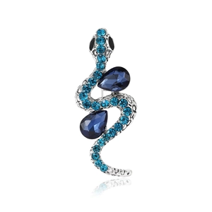 Vintage silver snake brooch with blue rhinestones and teardrop gemstones on white back