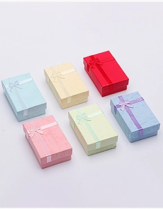 Detailed top view of rectangular jewelry gift boxes with ribbon bows in six pastel colors