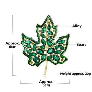 Detailed view of luxury green rhinestone maple leaf brooch with 6x5cm size specifications