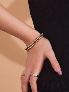 Detail of beaded double-layer bracelet and zircon ring set on a model's hand