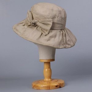 Elegant beige ramie sun hat with wide brim and bow decoration for summer sun protection