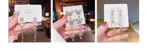 Detailed view of S925 silver needle tassel earrings with clover, butterfly and pearl motifs