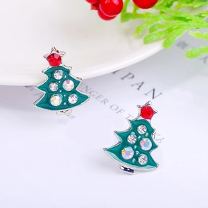 Macro detail of Christmas tree earrings with colorful rhinestones and green enamel