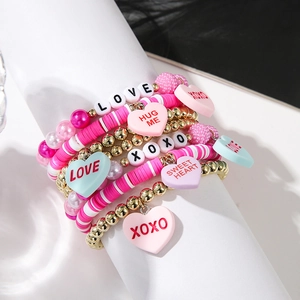 Detail of pink and gold multilayer beaded heart bracelet with LOVE and XOXO charms