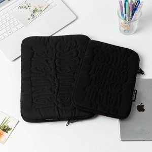 Quilted black laptop and tablet sleeve set with embossed Good Things Take Time text