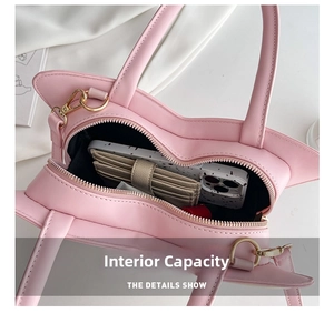 Internal capacity of pink heart-shaped bag showing space for phone and wallet