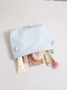 Blue and white checkered clover makeup bag with flower detail and storage cosmetics