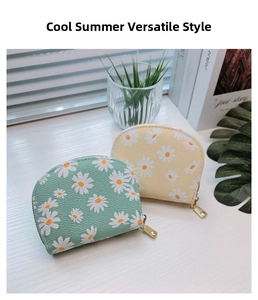 Detailed view of semi-circular PU leather daisy coin purses in mint green and yellow