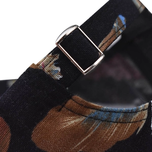 Detail of adjustable metal buckle and fabric strap on colorful feather print baseball cap