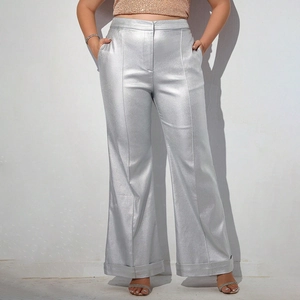 Detail shot of silver metallic wide-leg pants showing the shiny texture and cuff design