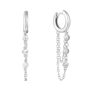 Detail of silver huggie earrings with delicate chain and three round zircon stones