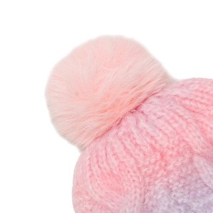 Detail of pink and purple gradient knit hat featuring a fluffy faux fur pom-pom and cable texture