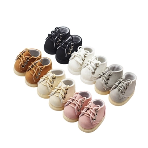 Close-up of five pairs of mini doll sneakers in black, brown, beige, white, and pink