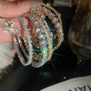 Sparkling zircon tennis bracelets set in silver and rose gold finishes on high-end display