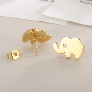 Macro detail of elephant-shaped gold titanium steel stud earrings with polished finish