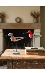 Close-up of hand-carved wooden water bird sculptures with natural textures and painted details