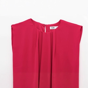 Women's red sleeveless round neck romper featuring pleated chest details and soft fabric