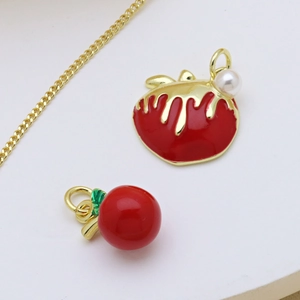 Detailed shot of apple and cherry enamel pendants with pearl on gold collar necklace