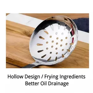 Polished stainless steel slotted spoon with wooden handle on a wooden cutting board