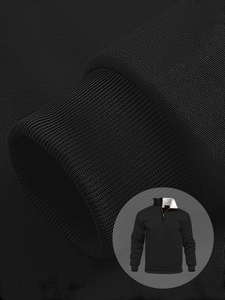 Close-up of ribbed cuffs and waffle texture on black men's quarter-zip sweatshirt