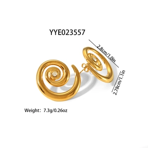 Macro shot of gold spiral conch stud earrings with sparkling center rhinestone
