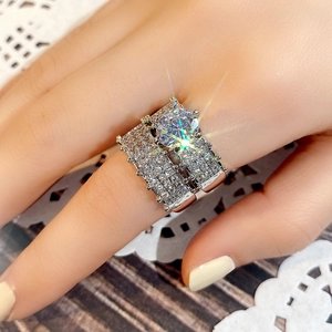 Macro shot of silver-plated bridal ring set featuring a large six-prong cubic zirconia