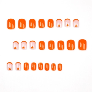 Orange French heart press-on nails set with short square oval shape on white background