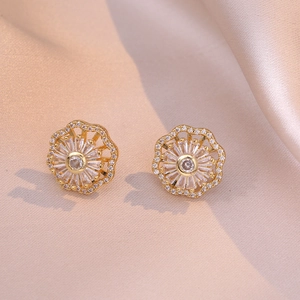 Elegant gold flower stud earrings with micro-pave cubic zirconia on silk fabric