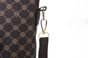 Detailed close-up of dark brown printed bag featuring gold hardware and strap connector
