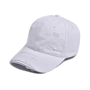 Close-up of white distressed baseball cap with ripped details and worn canvas texture