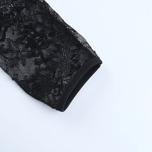 Close-up of intricate black floral lace pattern and high-quality hem finishing details