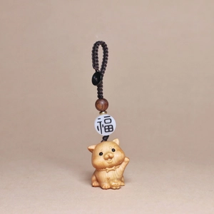 Macro shot of hand-carved wood zodiac pendant with woven cord and blessing bead