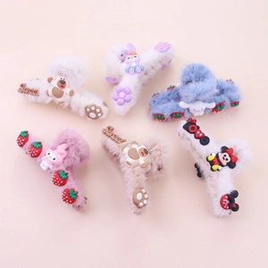 Flat lay of colorful plush hair claws with cartoon figures and sweet embroidery