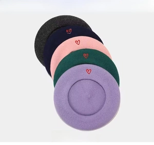 Detail of wool berets in multiple colors showing soft texture and premium fiber quality