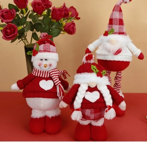 Detail showing plush Christmas gnome set with knitted textures and festive heart patterns