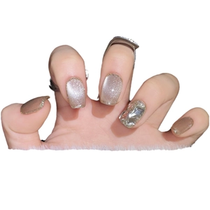 Champagne cat eye press-on nails with sparkling glitter and large accent rhinestones