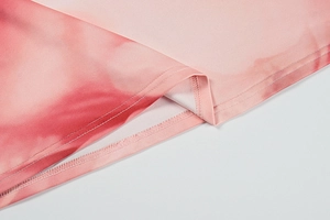Detail of a pink gradient dress showing precise double-needle stitching and silky fabric
