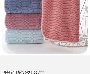 Detail of coral fleece towels showing thick ribbed texture and multiple colors in stacks